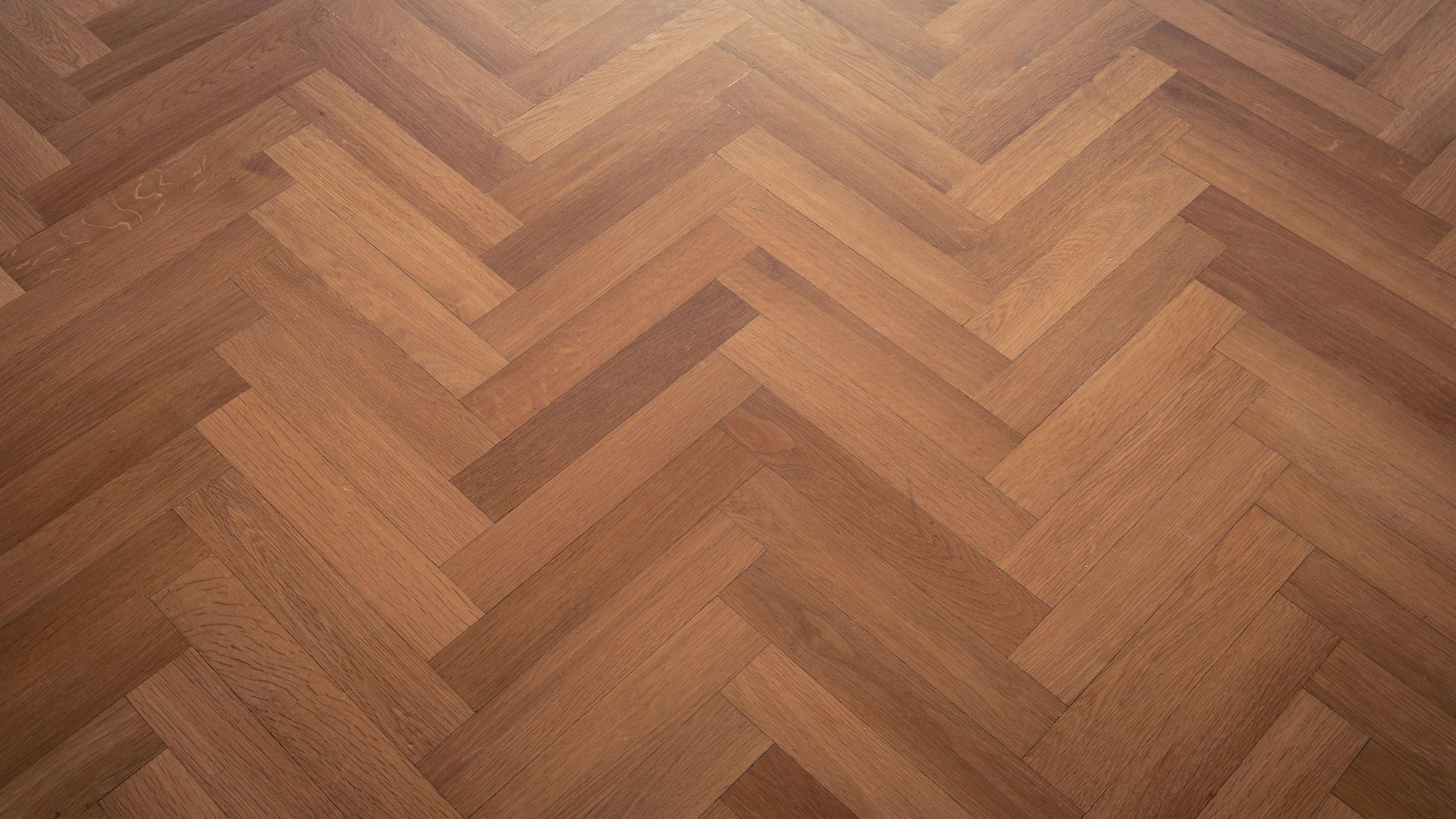 Dark herringbone parquet — representing the Florida tile and LVP case study